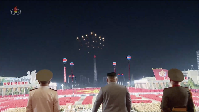 Kim Jong Un watches as MiG-29s release flares over KIS Square